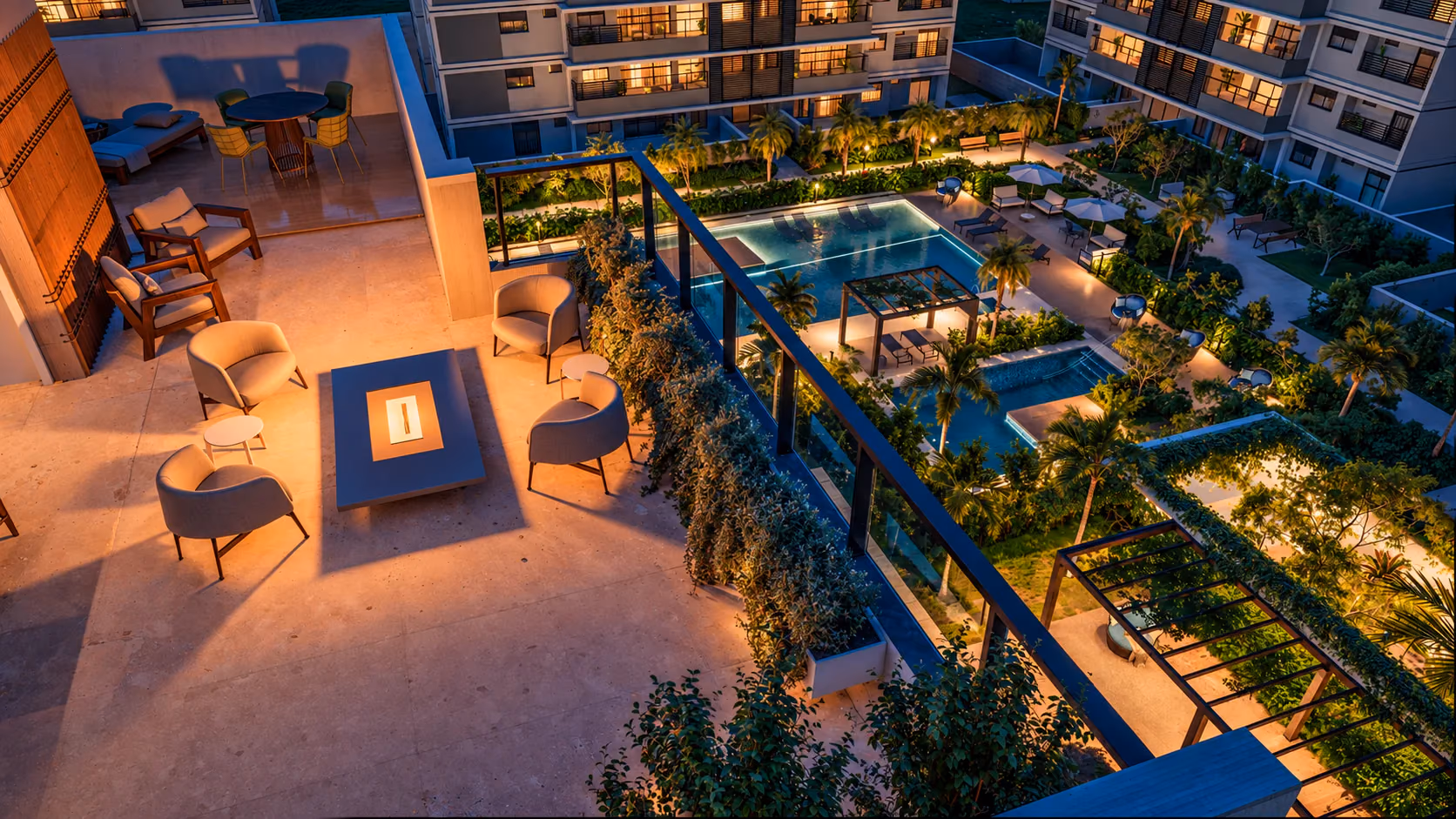 Rooftop do Duplex Aura Tamboré ao anoitecer, com poltronas ao redor da mesa de fogo e vista para as piscinas